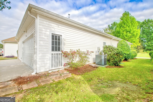 view of property exterior featuring a yard and central air condition unit