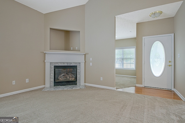 foyer featuring light carpet