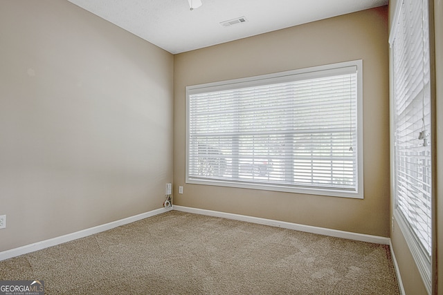 empty room featuring a textured ceiling and carpet