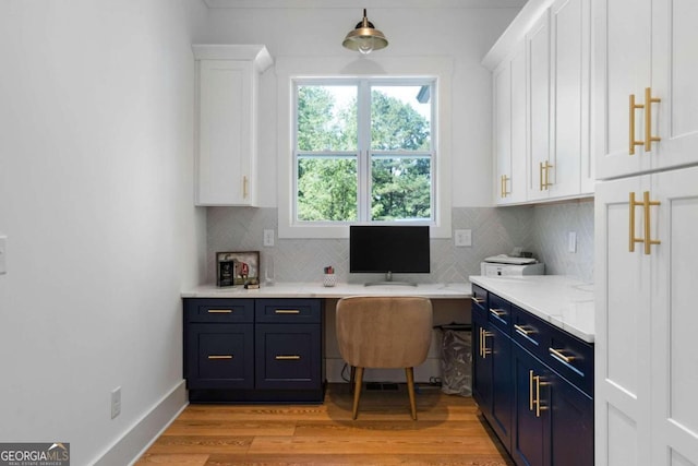 office space featuring light hardwood / wood-style flooring and built in desk