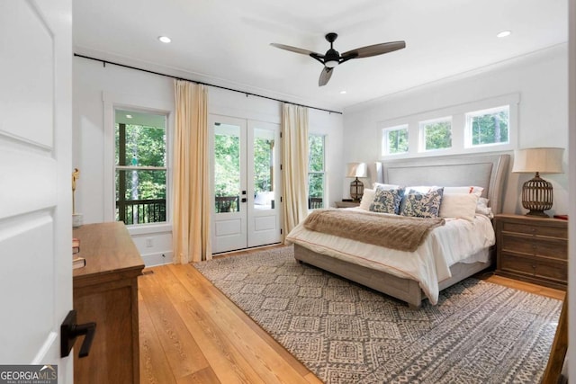 bedroom featuring access to outside, hardwood / wood-style floors, ornamental molding, ceiling fan, and french doors