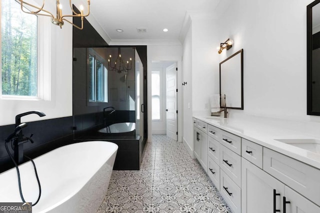 bathroom with a healthy amount of sunlight, vanity, a chandelier, and plus walk in shower