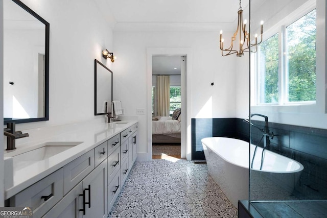 bathroom featuring vanity, plenty of natural light, a tub, and crown molding