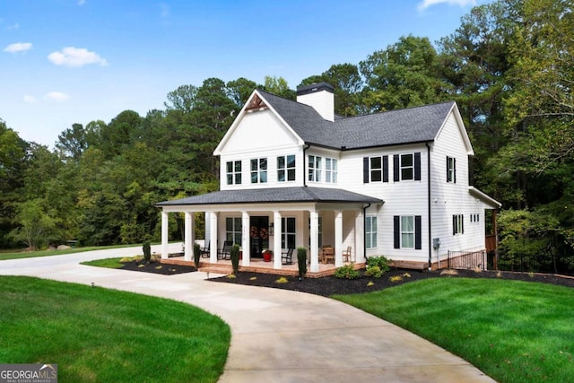 view of front of property with a front yard and a porch