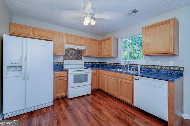 kitchen featuring dark hardwood / wood-style flooring, white appliances, and a textured ceiling