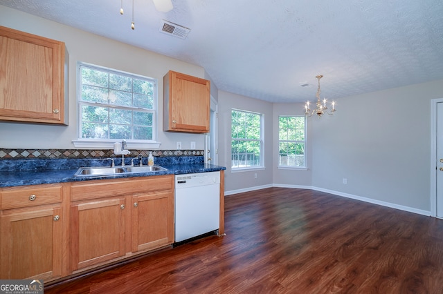 kitchen with dark hardwood / wood-style flooring, sink, white dishwasher, and plenty of natural light