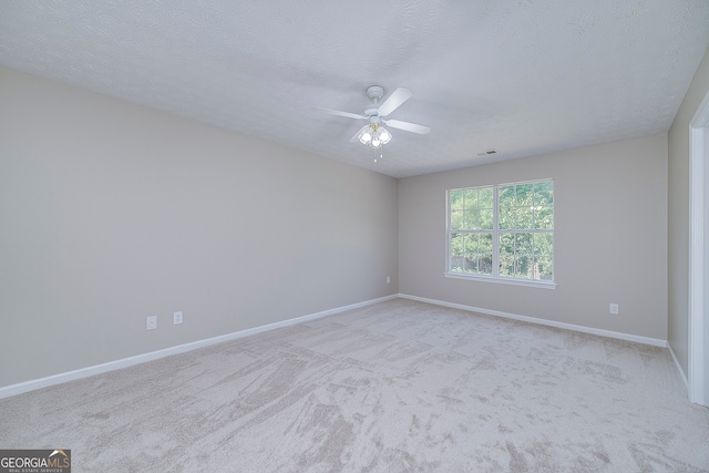 carpeted empty room featuring a textured ceiling and ceiling fan