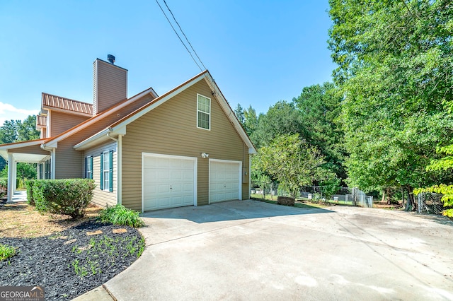 view of side of home featuring a garage