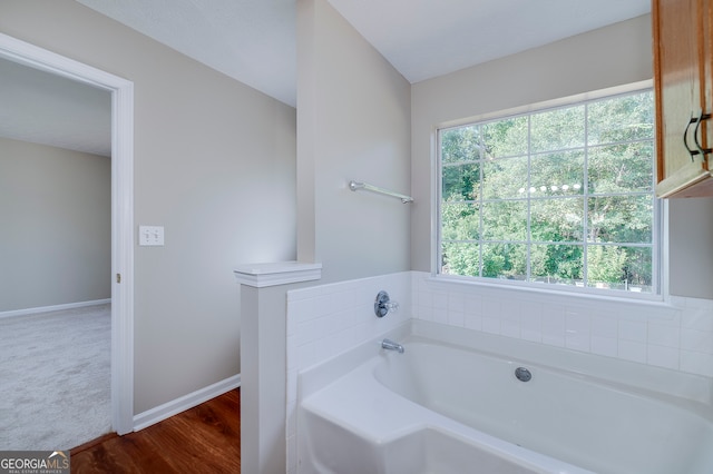 bathroom featuring a tub and hardwood / wood-style flooring