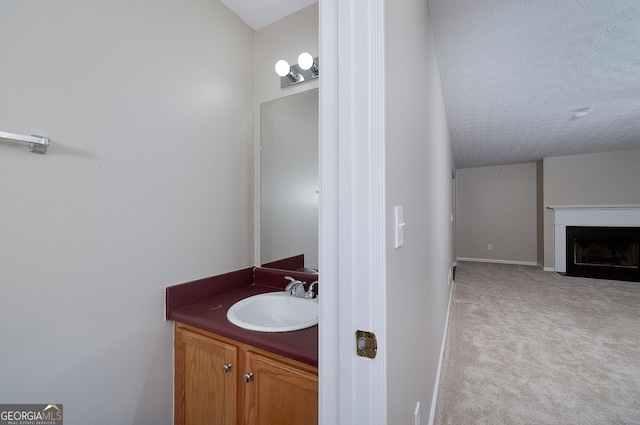 bathroom with vanity and a textured ceiling