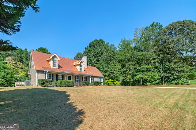 cape cod home featuring a porch and a front lawn