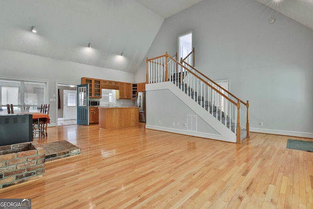 interior space with light hardwood / wood-style flooring, high vaulted ceiling, and sink