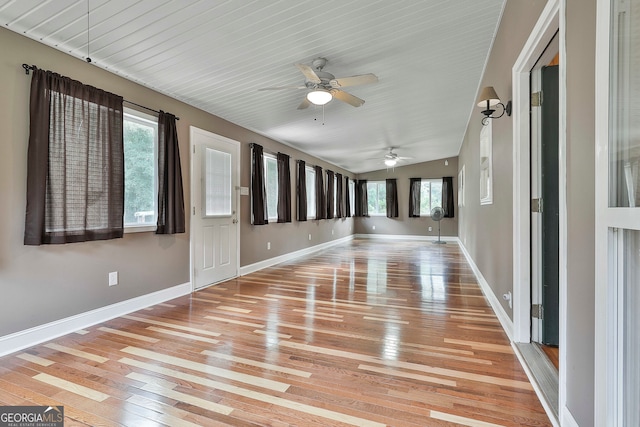 interior space featuring light hardwood / wood-style floors, lofted ceiling, and ceiling fan