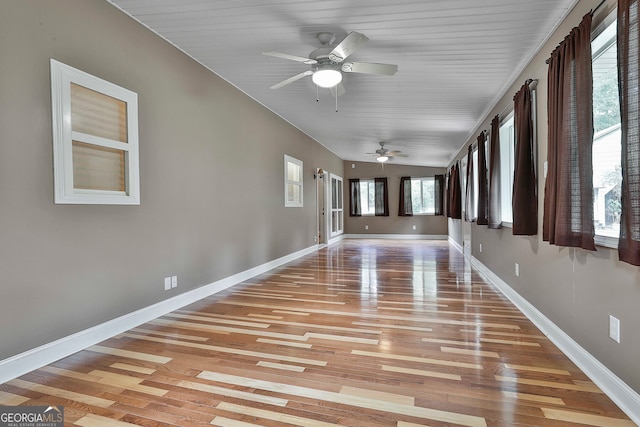 unfurnished sunroom featuring ceiling fan and wood ceiling