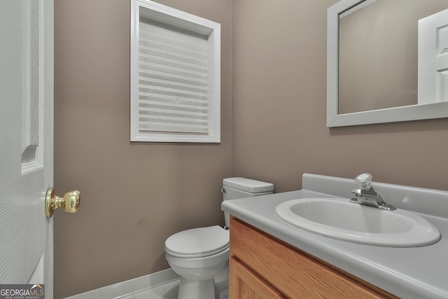 bathroom with vanity, toilet, and tile patterned floors