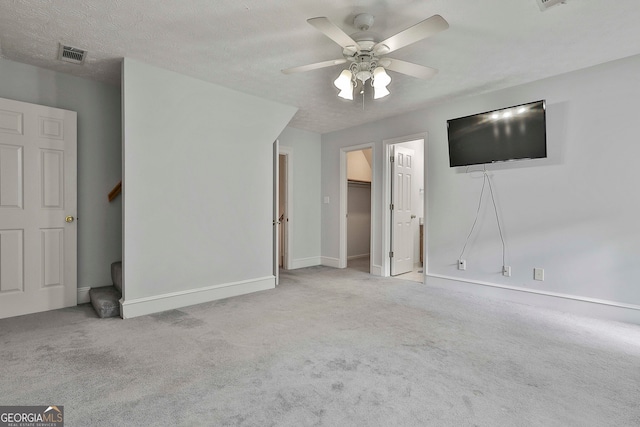 interior space with a textured ceiling and ceiling fan