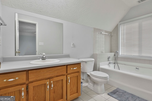 bathroom featuring vaulted ceiling, vanity, a textured ceiling, toilet, and tile patterned floors