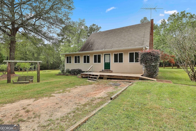 view of front of house with a front yard and a deck