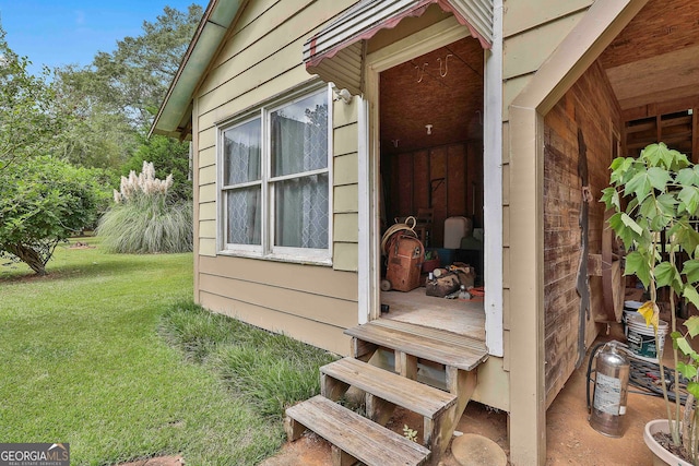 doorway to property with a yard