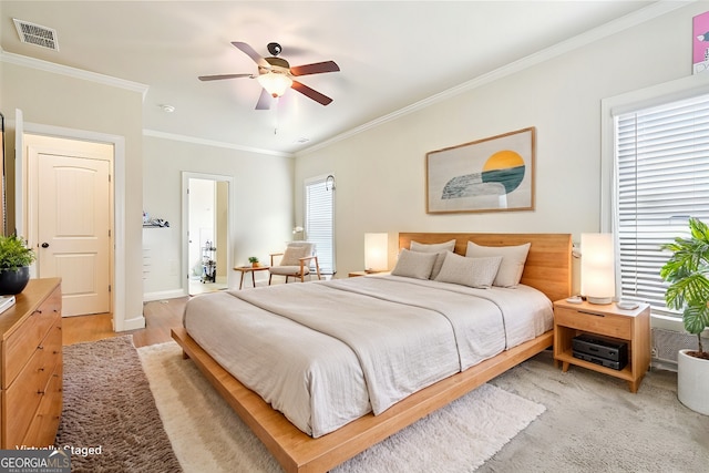 bedroom featuring crown molding, ceiling fan, and light hardwood / wood-style flooring