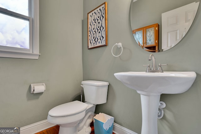 bathroom featuring hardwood / wood-style flooring and toilet