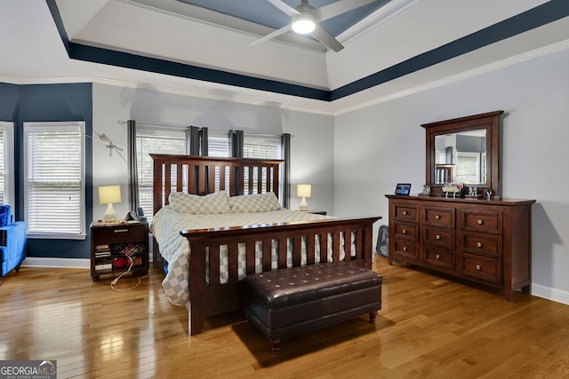 bedroom with ceiling fan, ornamental molding, and light wood-type flooring