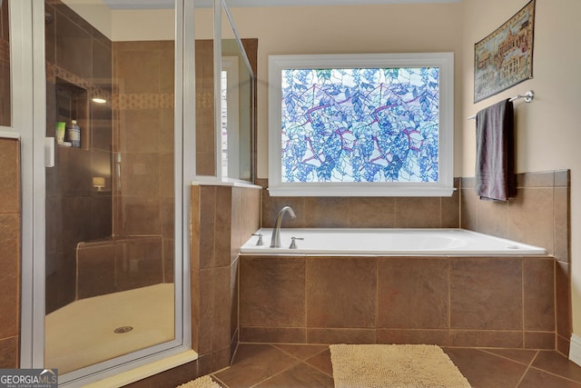 bathroom featuring tile patterned flooring and separate shower and tub