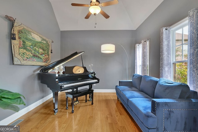 sitting room featuring ceiling fan, wood-type flooring, and vaulted ceiling