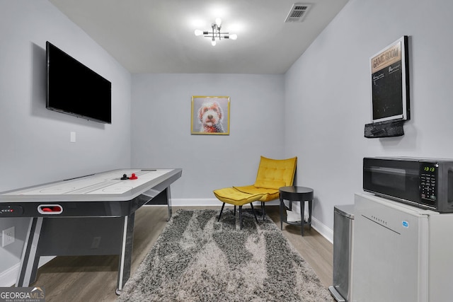 interior space with a notable chandelier and hardwood / wood-style floors