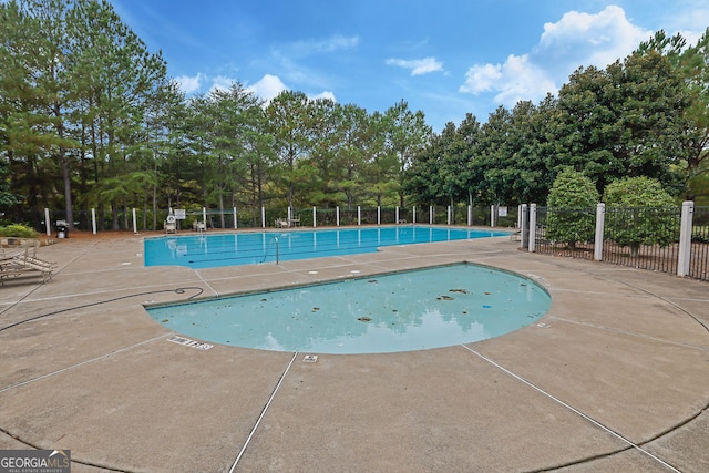 view of swimming pool with a patio