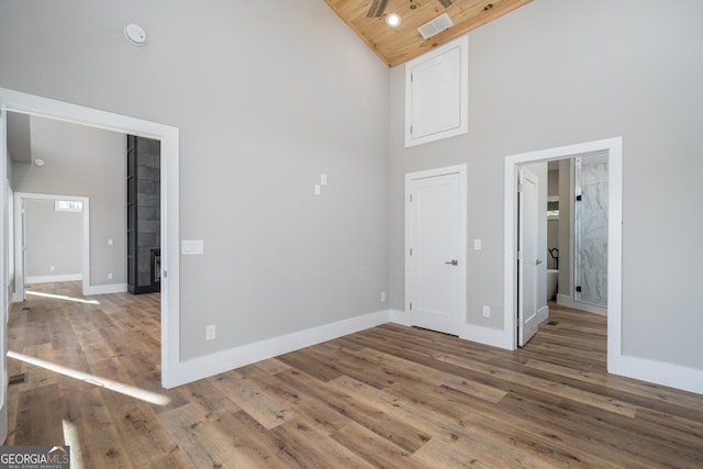 unfurnished room featuring hardwood / wood-style floors, high vaulted ceiling, and wooden ceiling