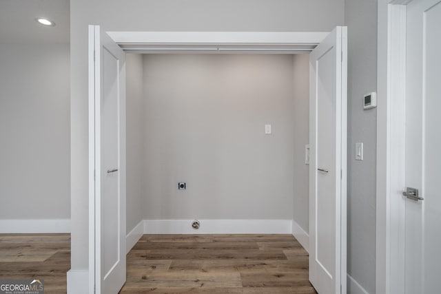 washroom featuring hookup for an electric dryer and hardwood / wood-style floors