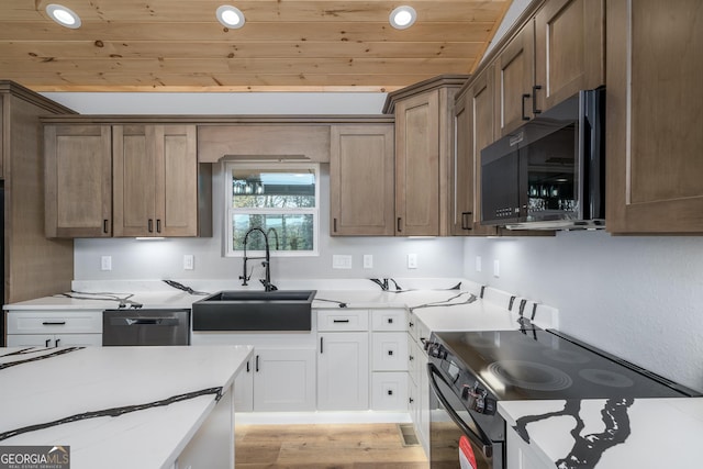 kitchen with white cabinets, sink, light hardwood / wood-style flooring, appliances with stainless steel finishes, and wood ceiling