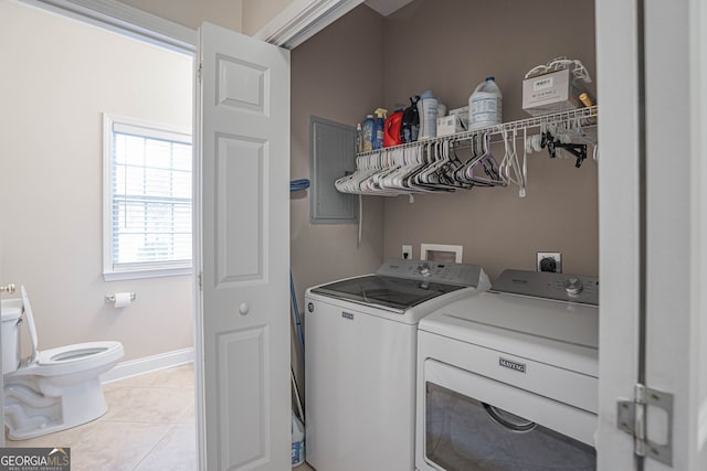 laundry area featuring light tile patterned floors and separate washer and dryer