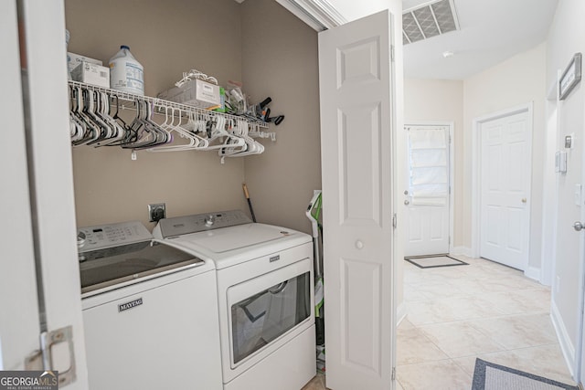 washroom featuring light tile patterned floors and washer and dryer