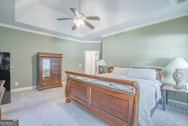 bedroom featuring crown molding, a tray ceiling, ceiling fan, and light colored carpet