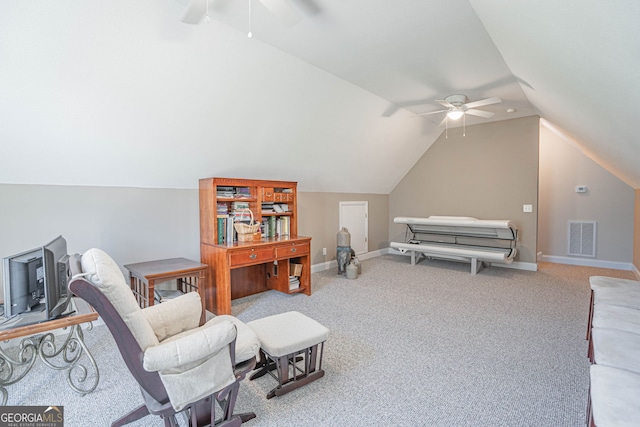 living area featuring vaulted ceiling, ceiling fan, and light colored carpet