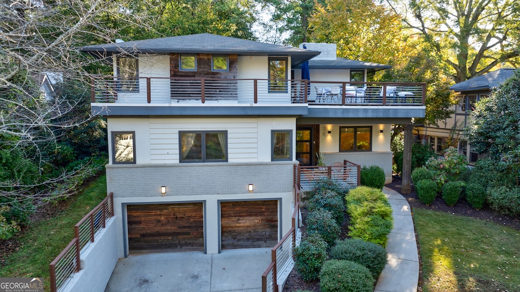 view of front of home with a balcony and a garage