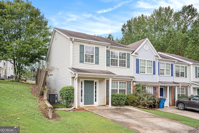 view of front of home featuring a front lawn and central air condition unit