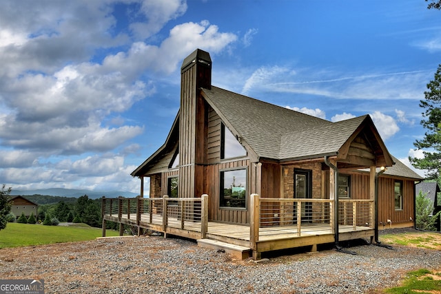 back of house with a wooden deck