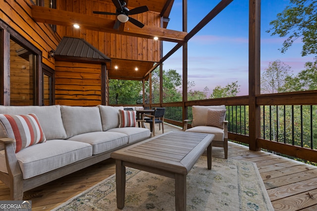 sunroom featuring ceiling fan and beam ceiling