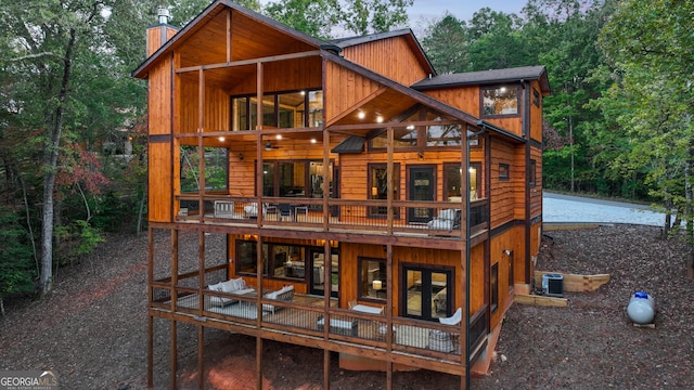 back of property featuring a balcony, a patio, and central AC