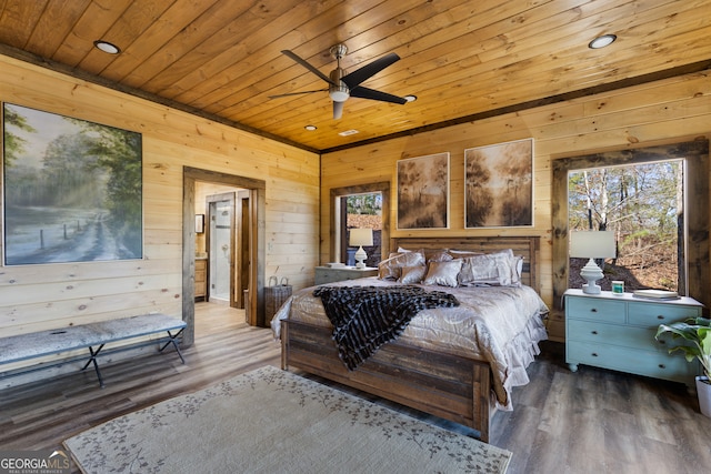 bedroom with wood ceiling, wooden walls, ceiling fan, and dark hardwood / wood-style flooring