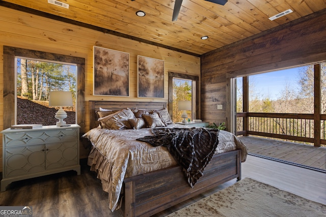 bedroom with wood-type flooring, wood ceiling, wood walls, and ceiling fan