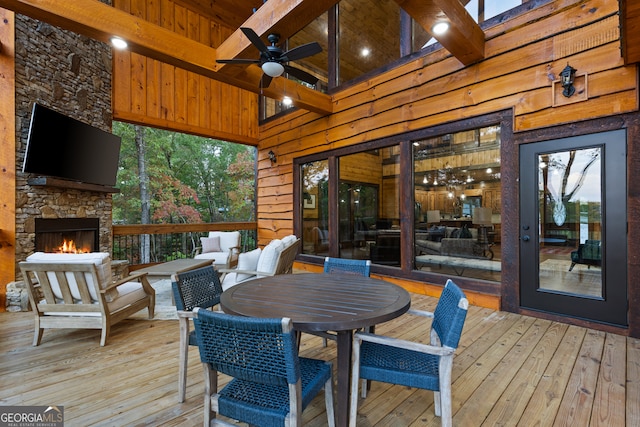 wooden terrace featuring an outdoor living space with a fireplace and ceiling fan