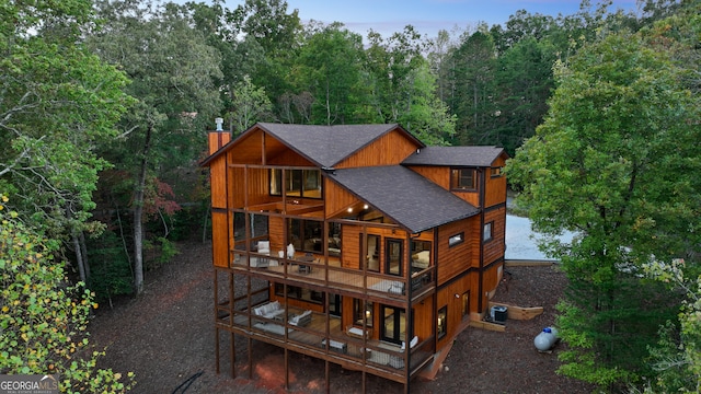 rear view of property featuring a balcony