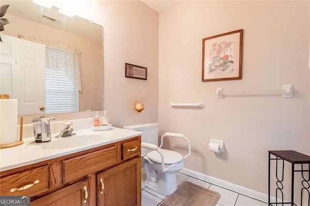 bathroom featuring vanity, tile patterned flooring, and toilet