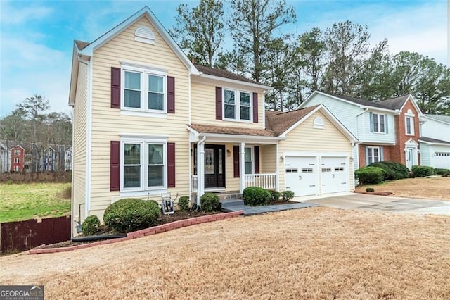 front facade featuring a porch, a garage, and a front yard