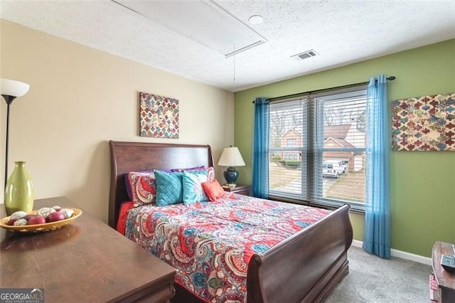 bedroom with a textured ceiling and carpet