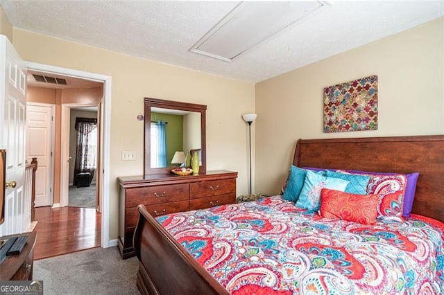 carpeted bedroom featuring a textured ceiling